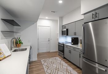 Gourmet kitchens with full appliance suite and quartz countertops